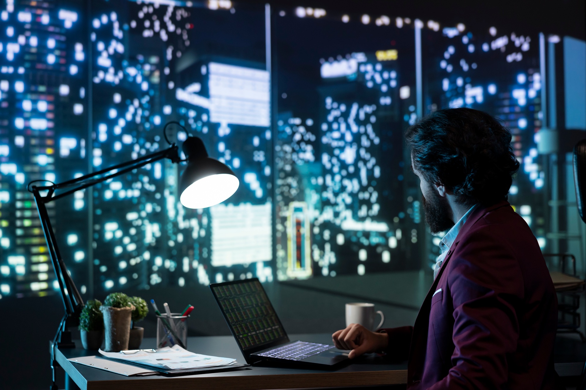 Private equity manager analyzing financial reports at night