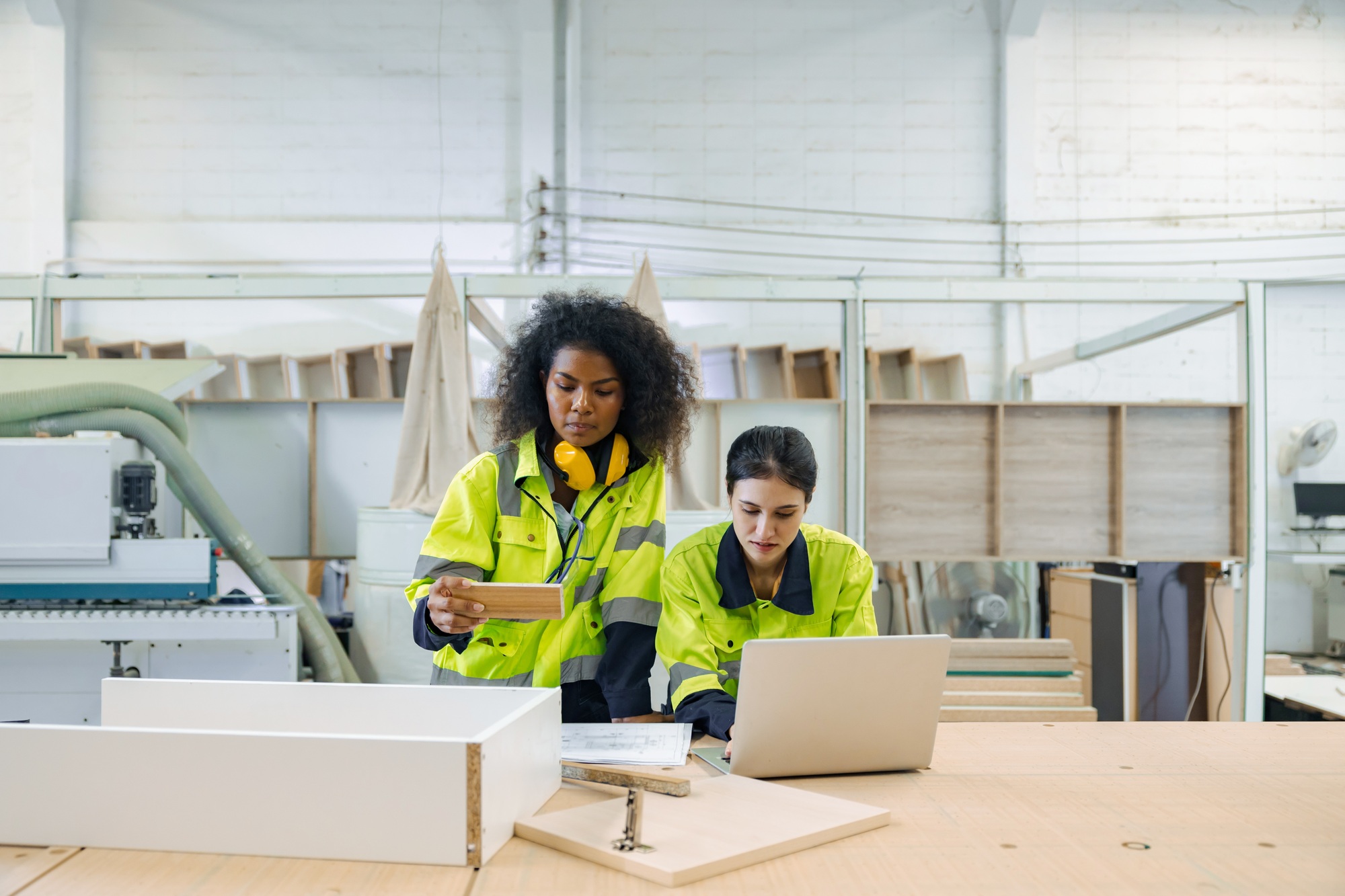 Professional product manager female staff worker team working in wood furniture factory