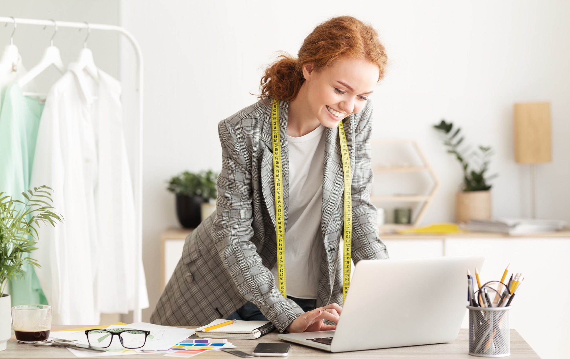 Responding on business e-mail. Dressmaker working on laptop