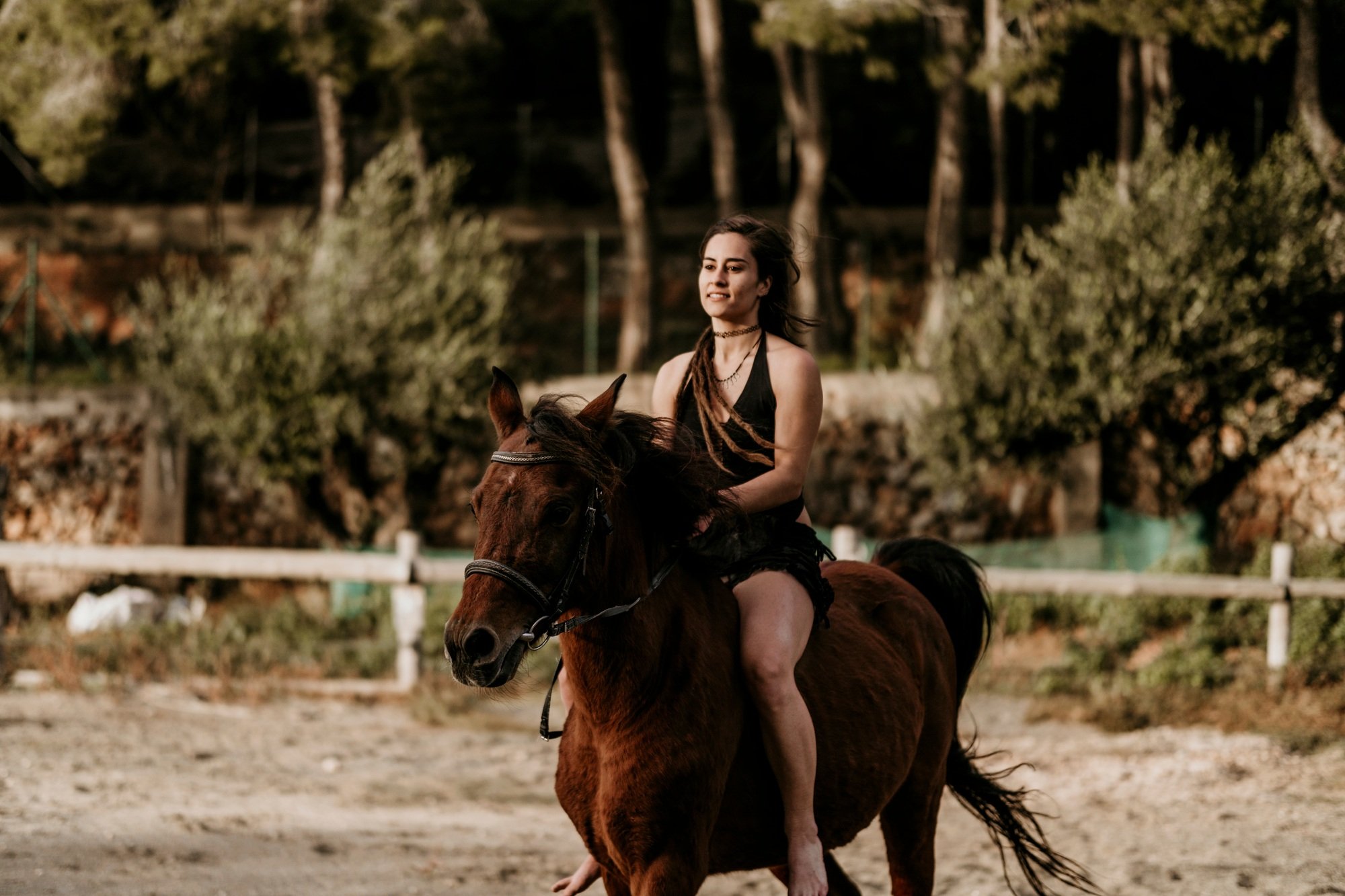 Rider girl riding a horse in her ranch.