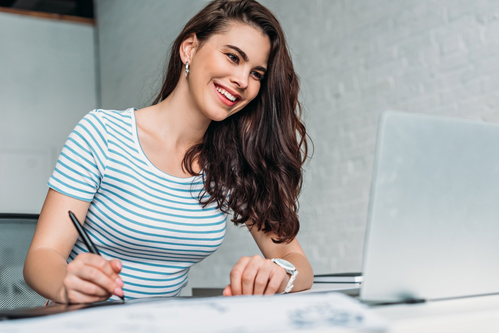 selective focus of happy animator looking at laptop