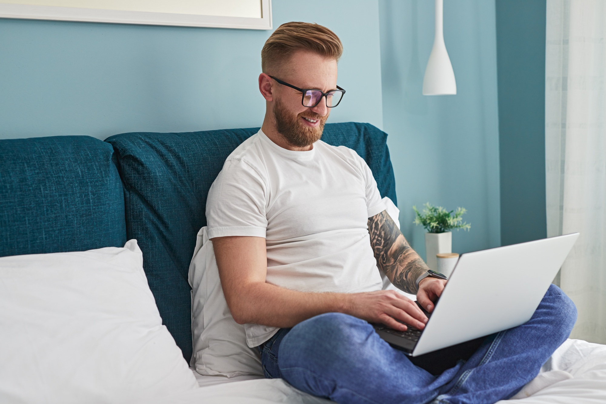 Self employed man browsing laptop at home