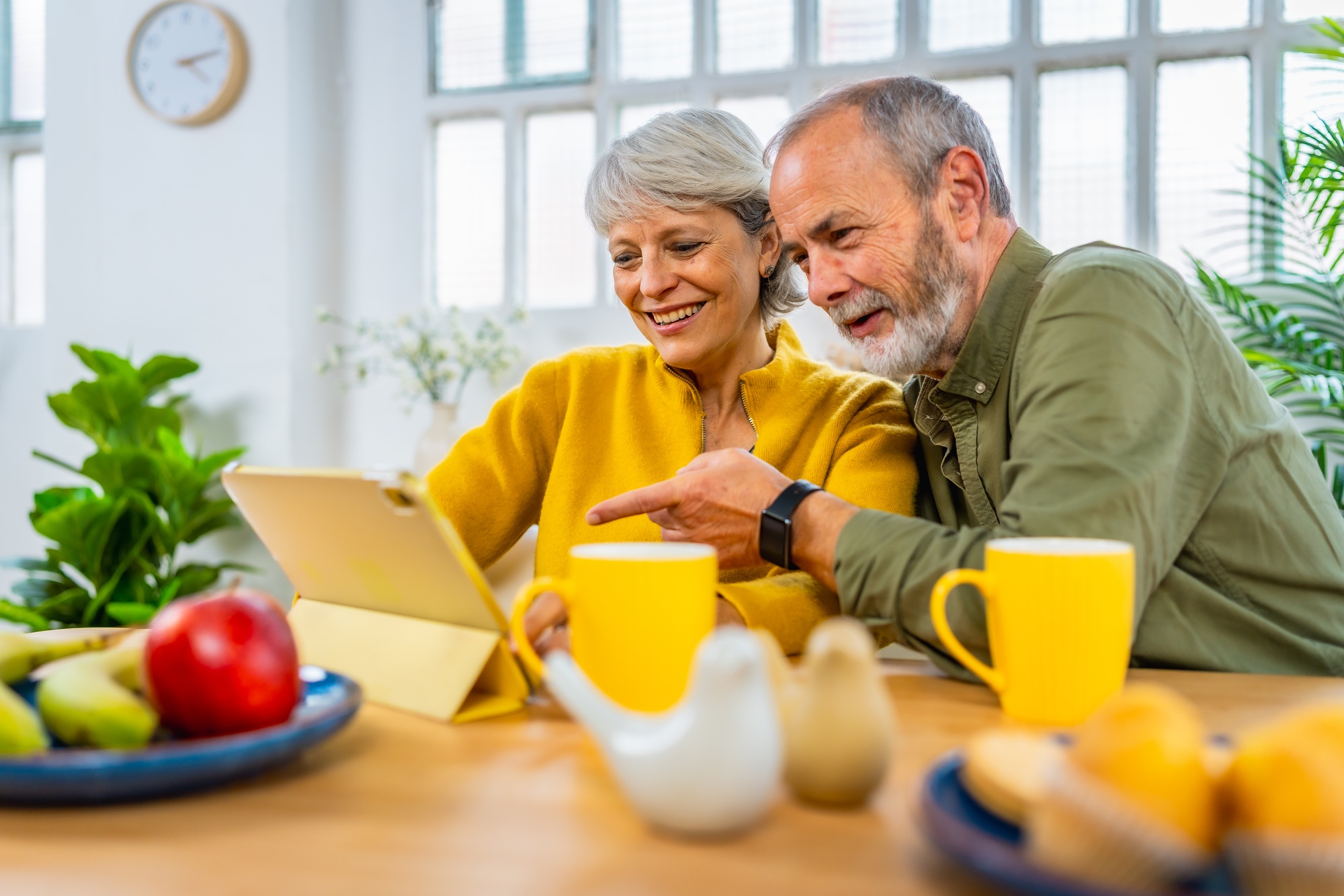 Senior couple watching content with digital tablet