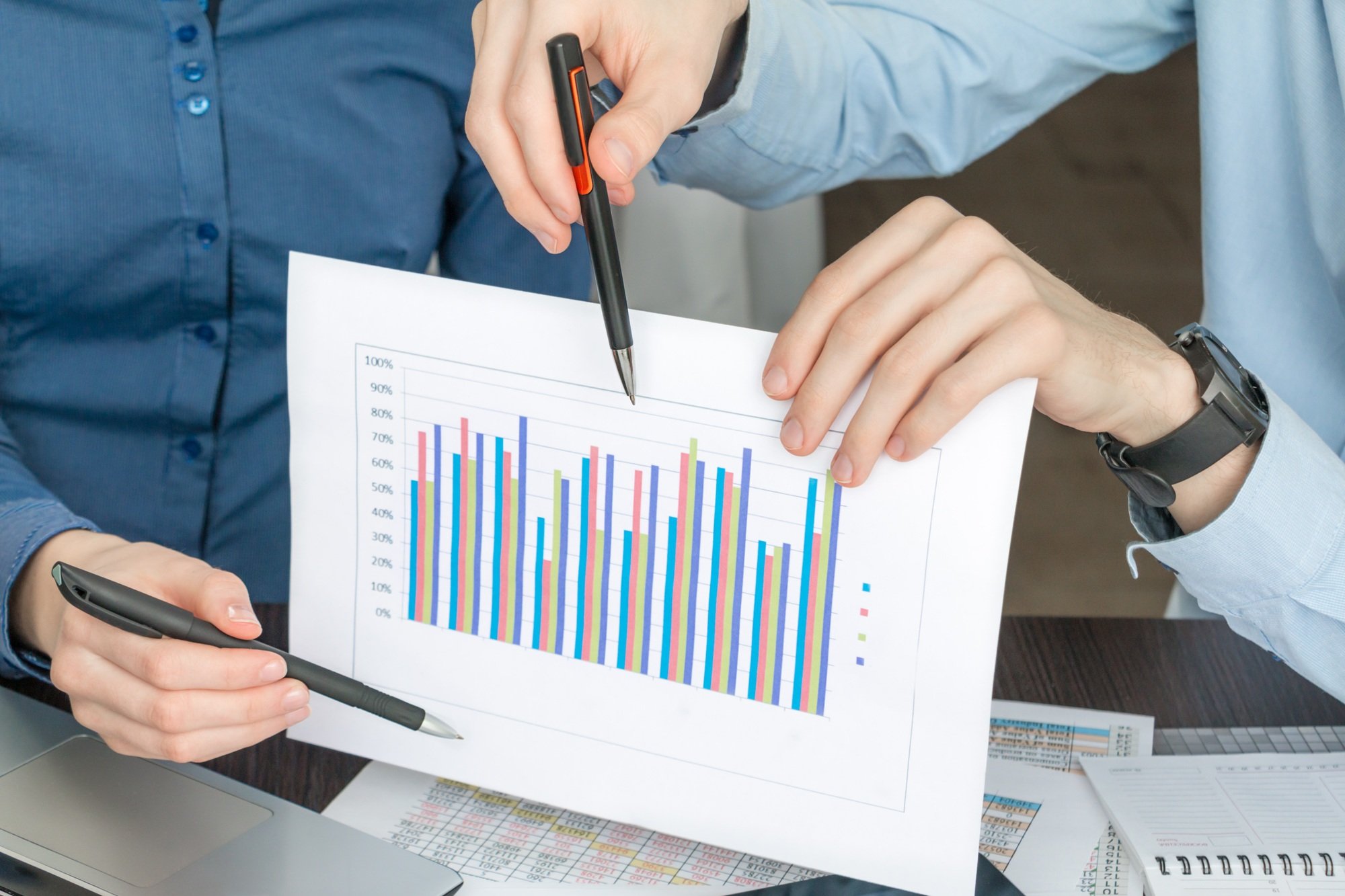 sheet of paper with a bar graph in hands closeup