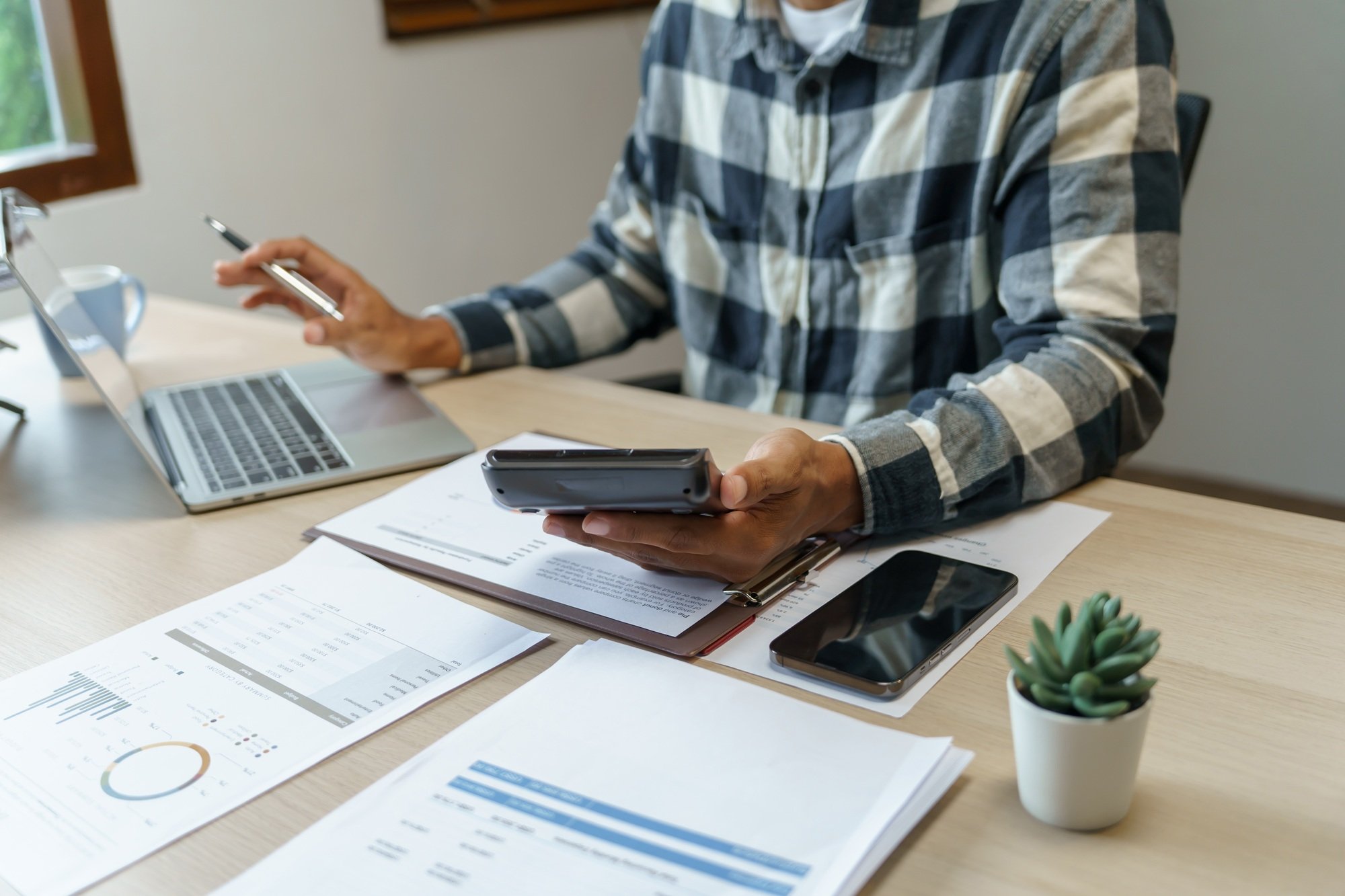 Small business accounting Businesswoman Accountant verify growing business with calculator.