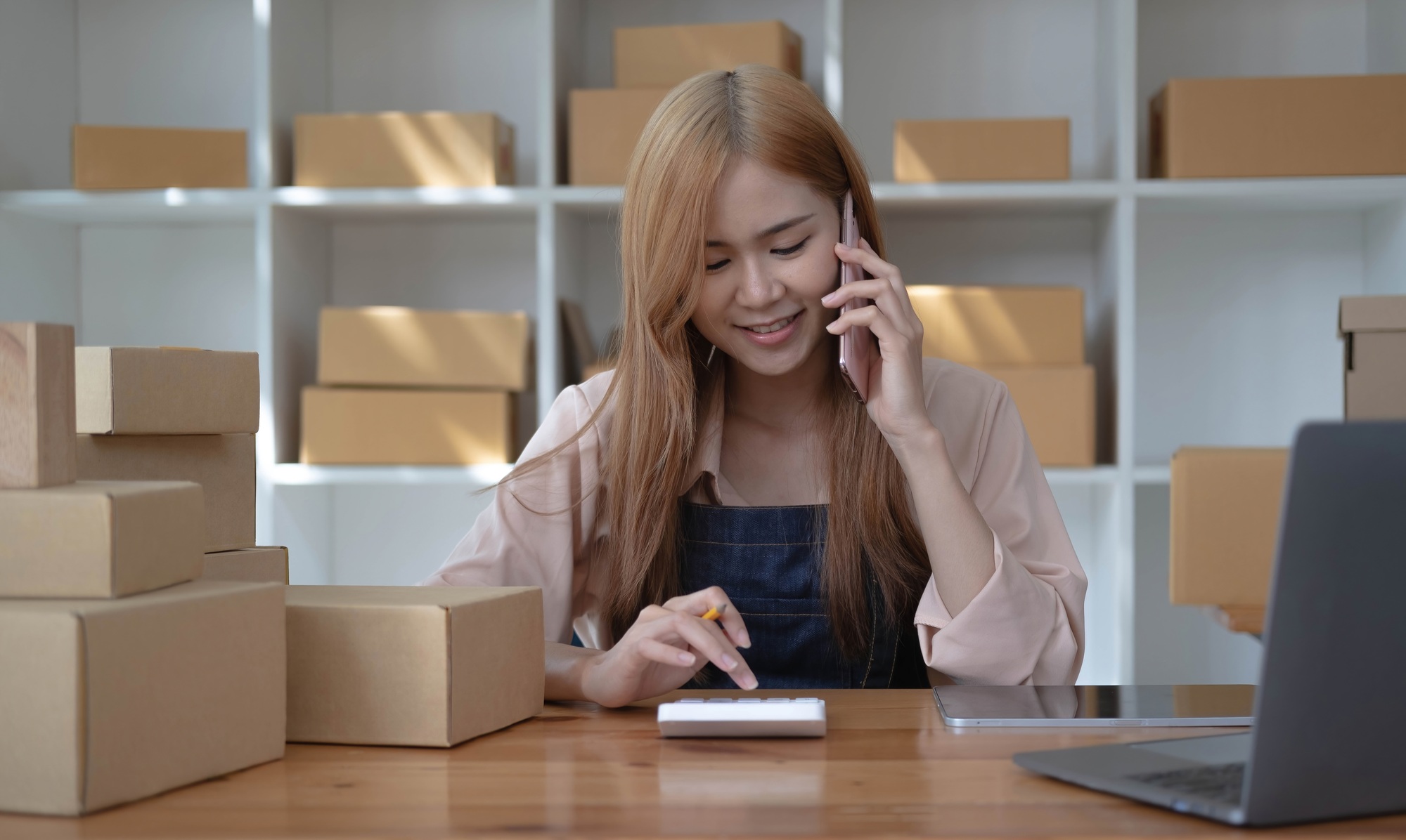 Small start-up business owners using computers and phones at work, salespeople, checking production
