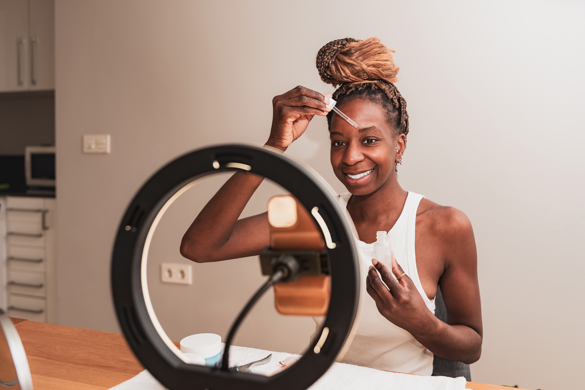 Smiling african american Woman Applying Facial Serum for Skincare Routine