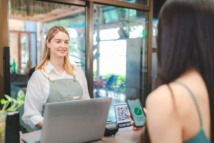 Smiling waitress wear apron take order talk to clients serving restaurant guests choosing food menu