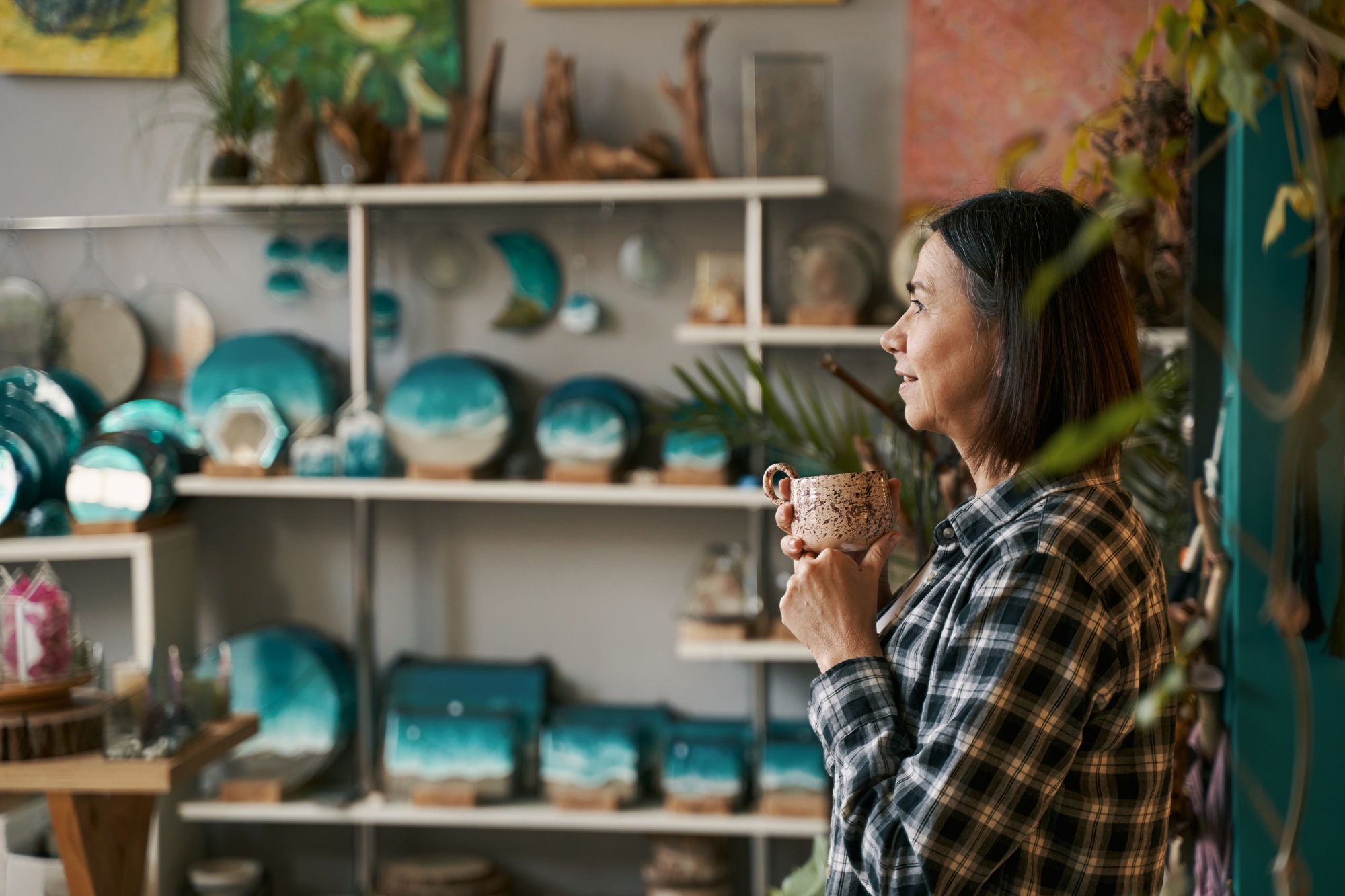 Smiling woman resting and drinking tea after work