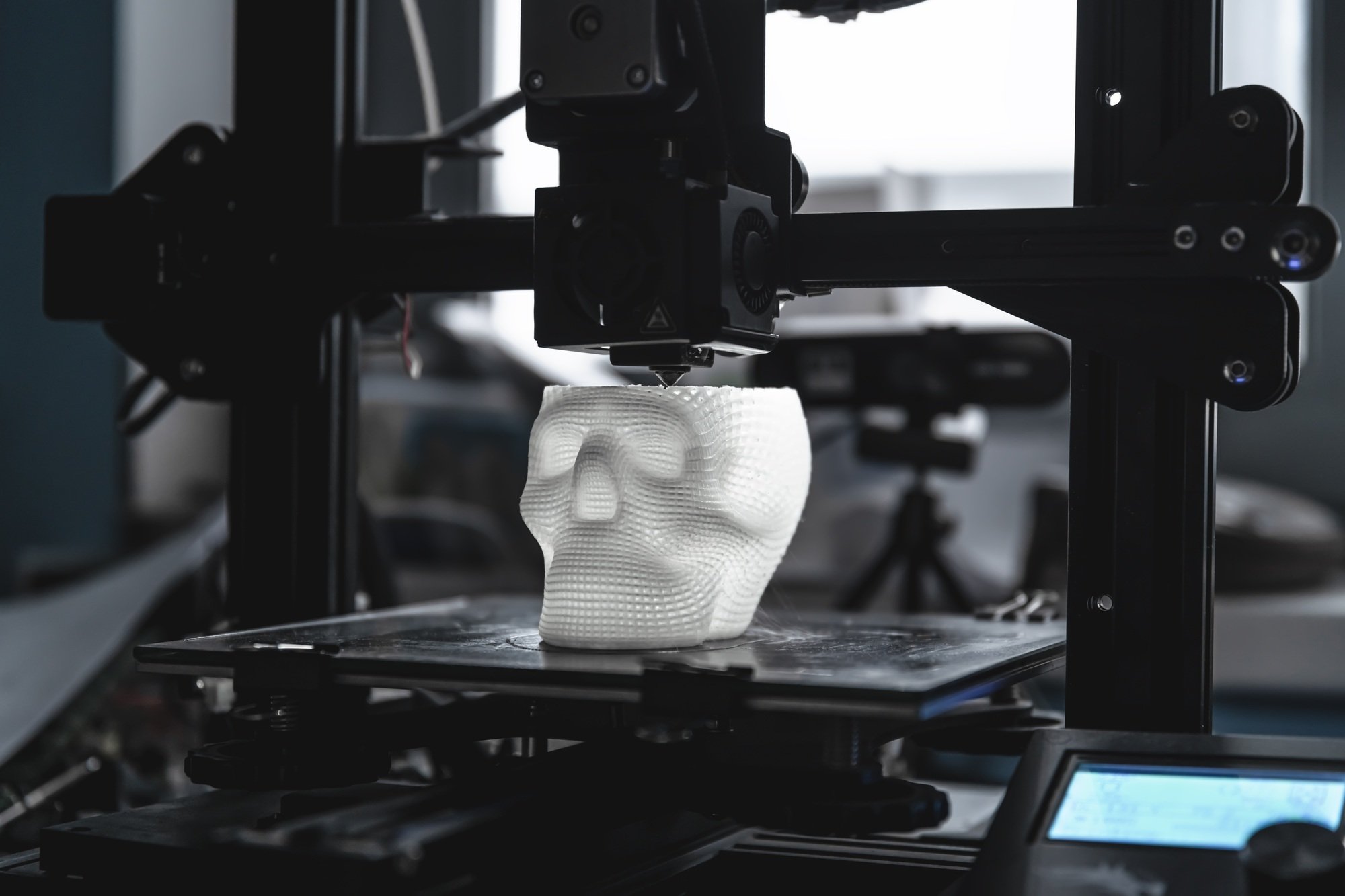 The 3D printer prints white plastic model