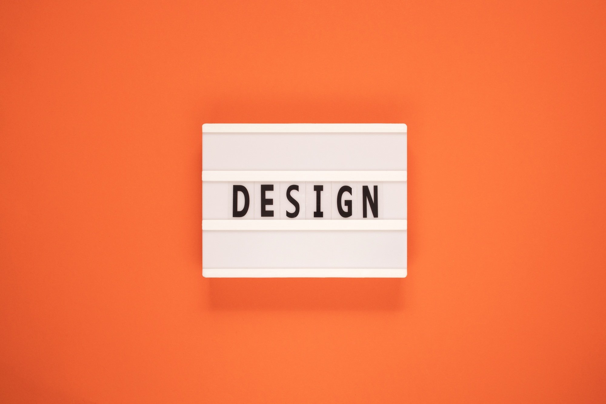 The word design on lightbox isolated orange background