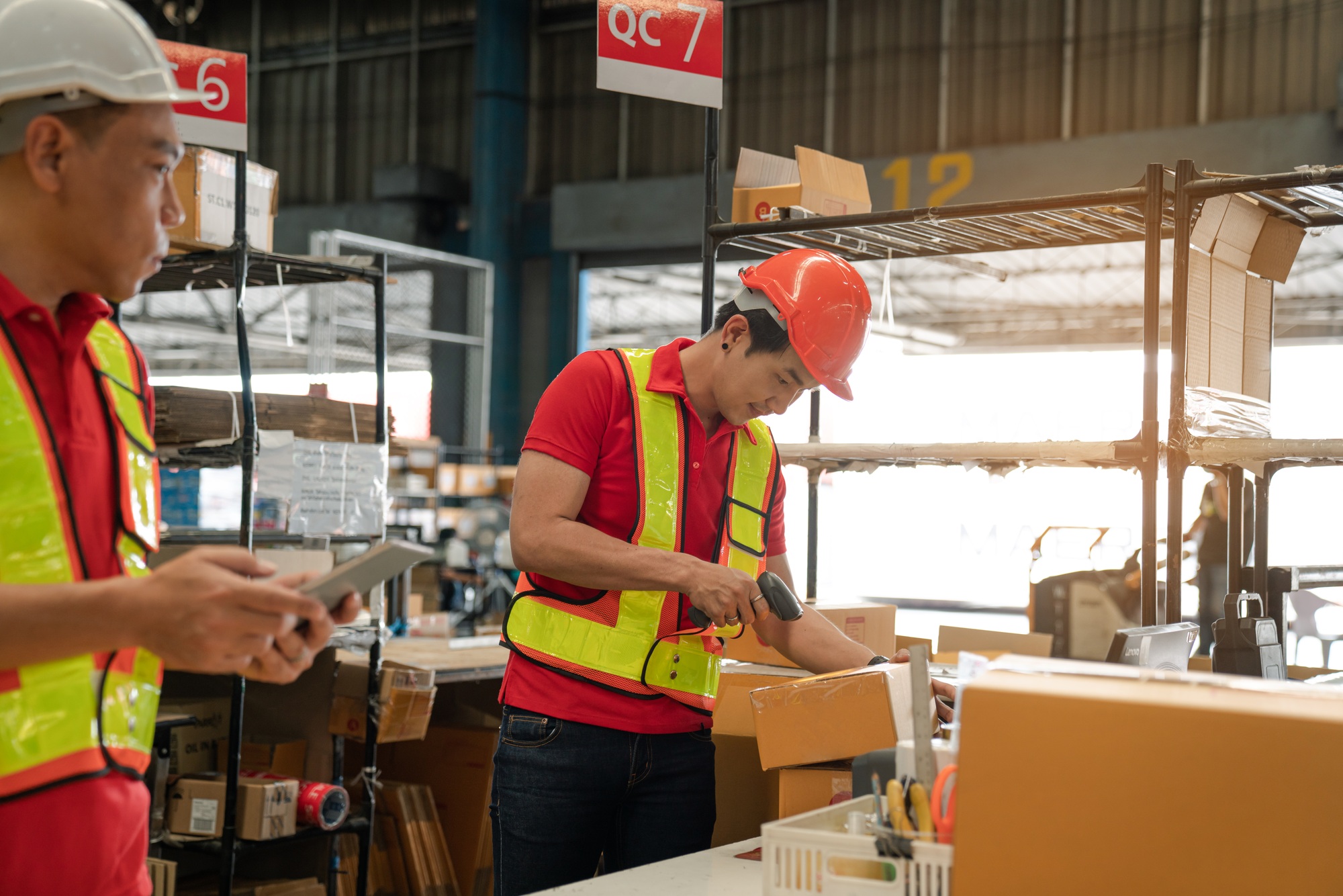 Warehouse worker team working in a large warehouse.
