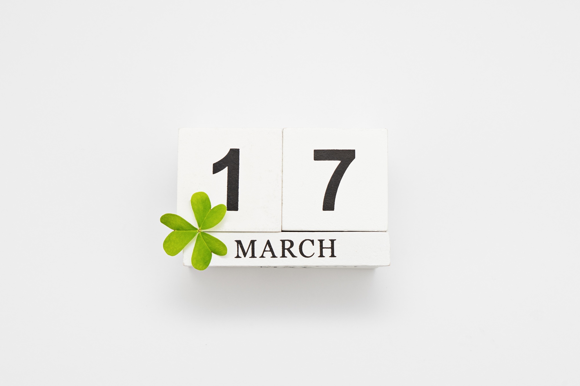 White block calendar for March 17 St Patrick's Day with clover leaf isolated on white background
