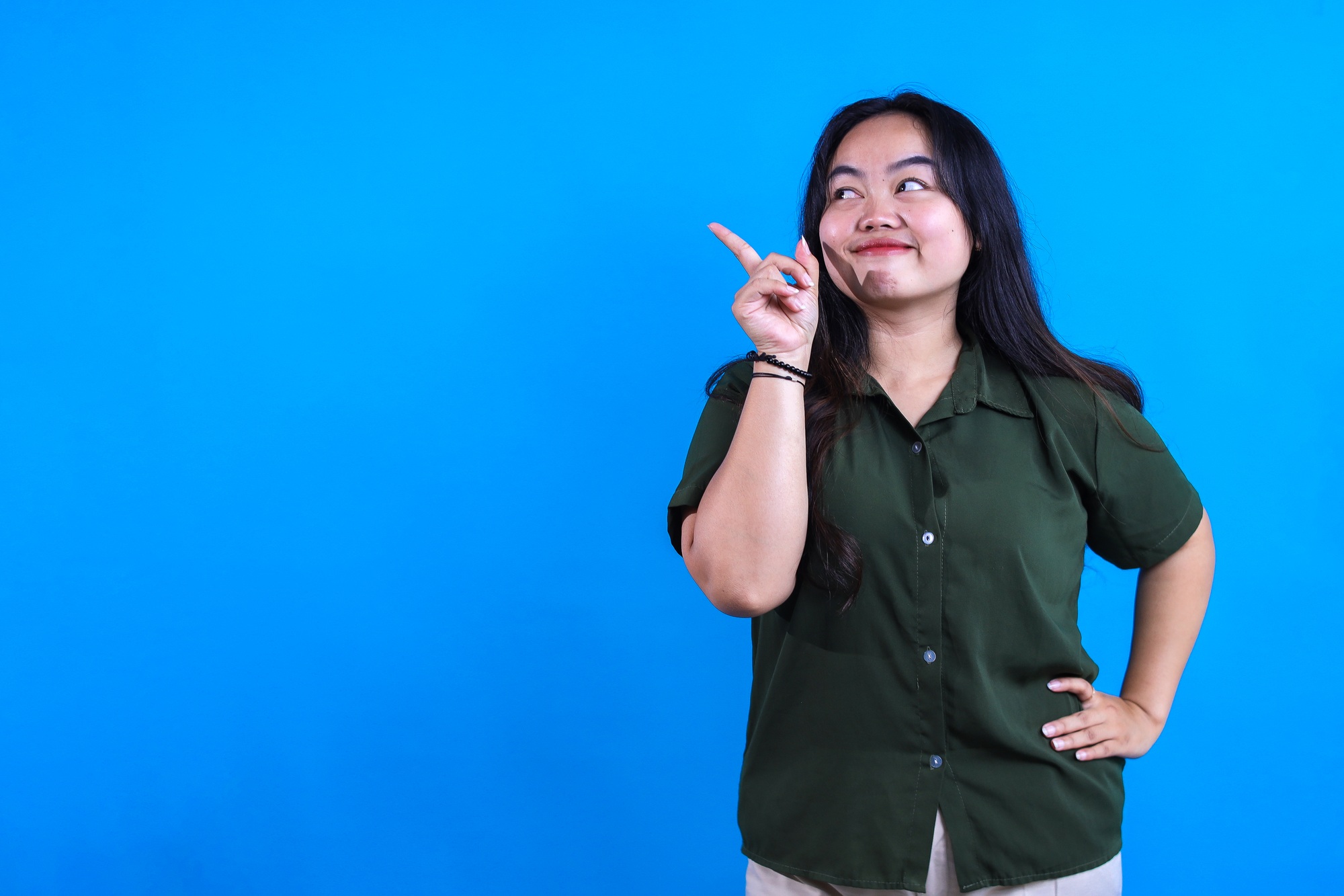 Woman Pointing To Side With Free Space For Advertisement
