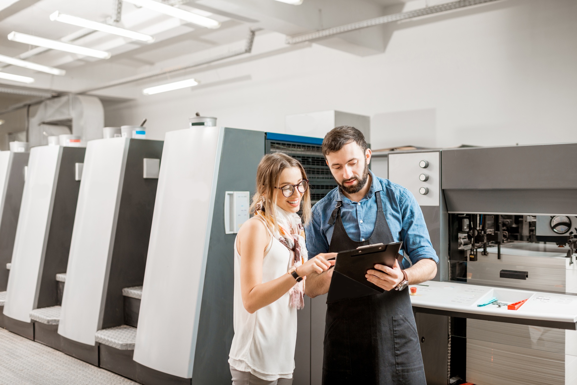 Woman with print operator at the printing manufacturing
