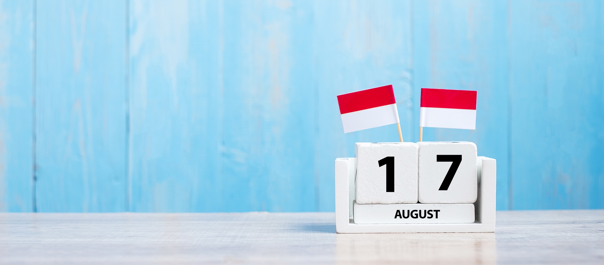 Wooden calendar of August 17th with miniature Indonesia flags. Indonesia’s independence day