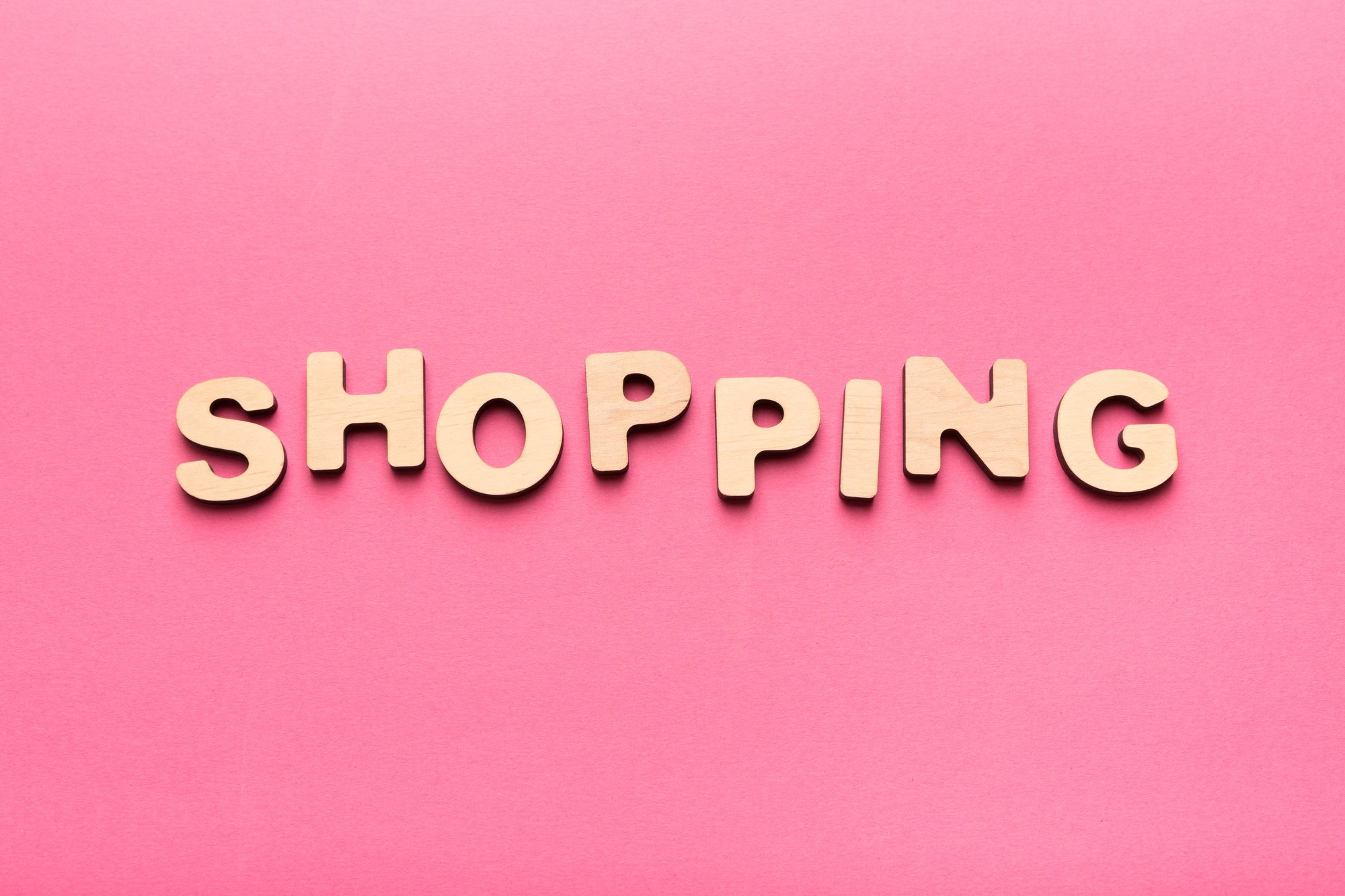 Word Shopping on pink background with copy space