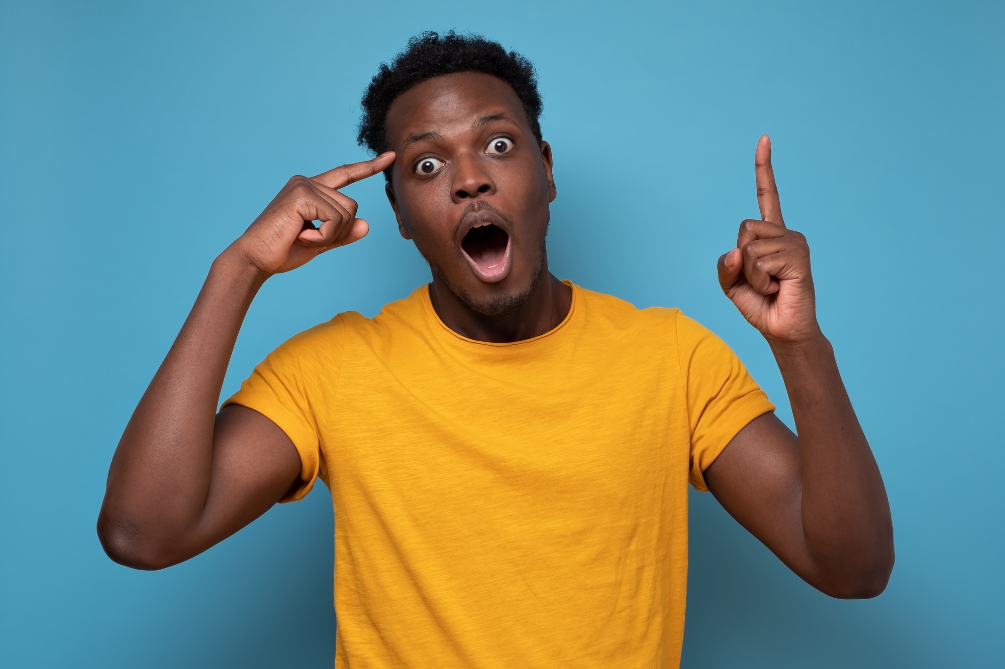 Young african man pointing with finger up having great idea for start up