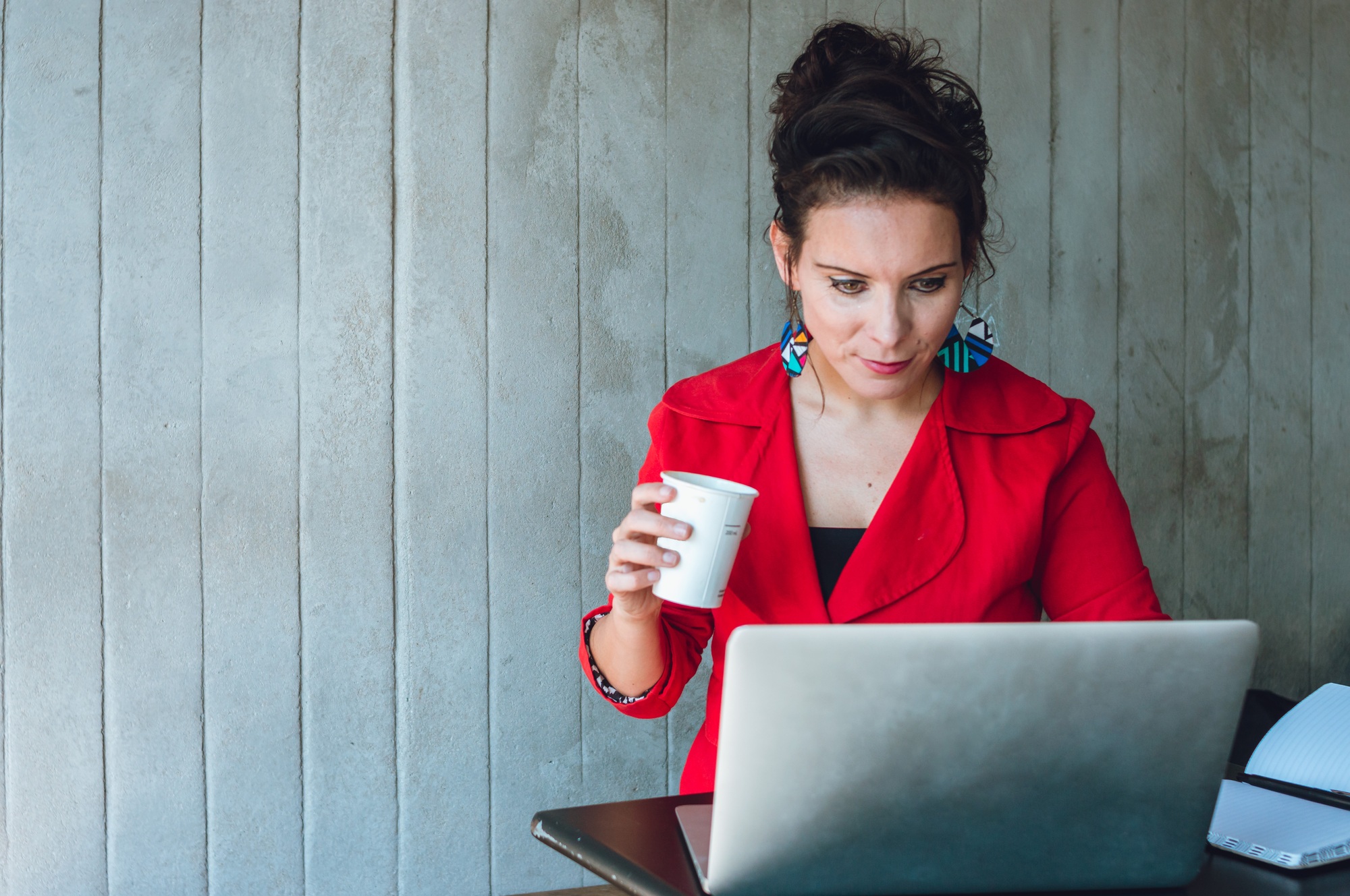 young business woman reviewing her sales statistics of her digital business.