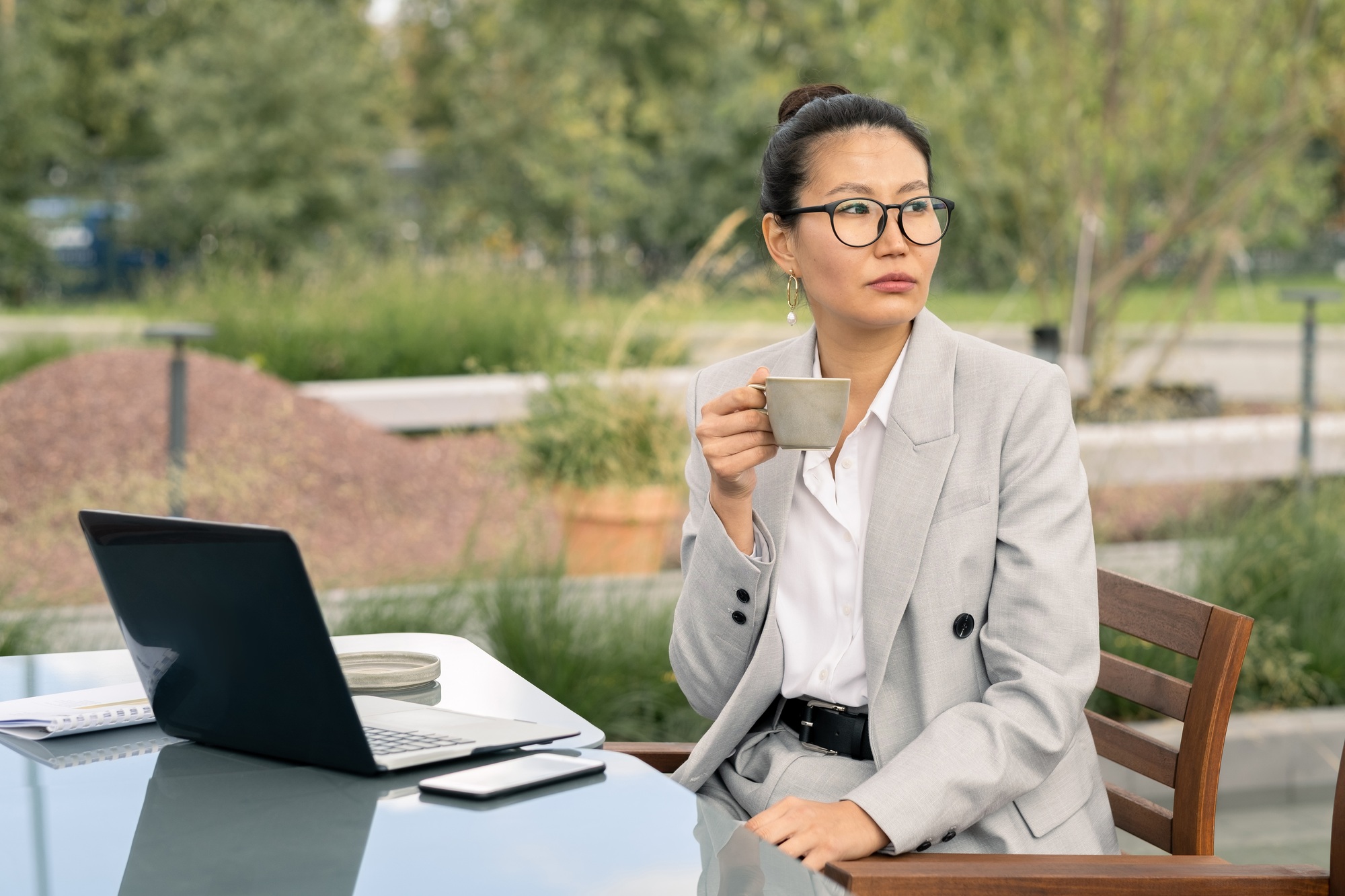 Young businesswoman with cup of tea or coffee