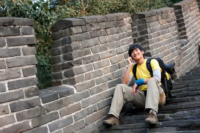 Young people using cellphone on the Great Wall