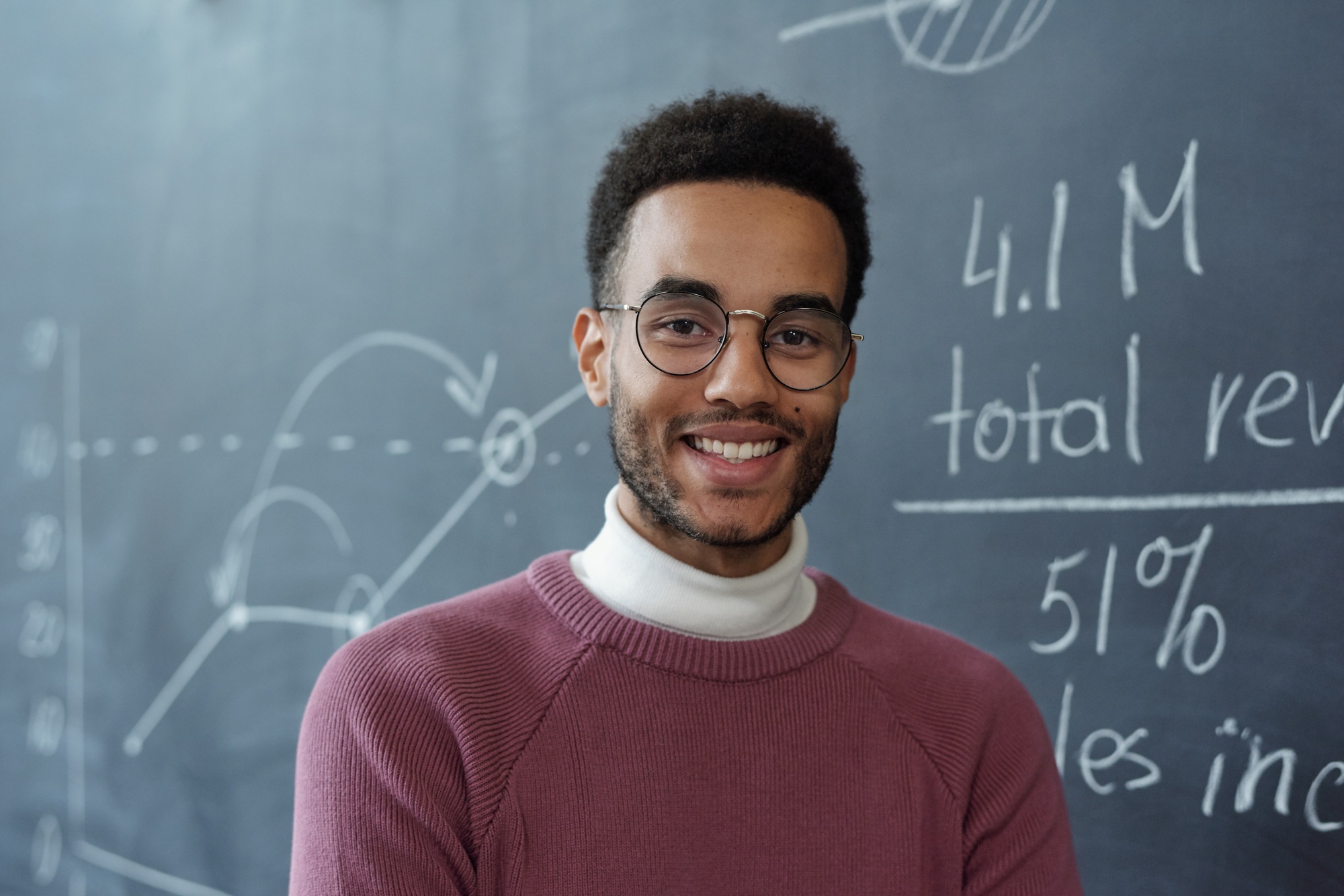 Young smiling business coach in eyeglasses and casualwear