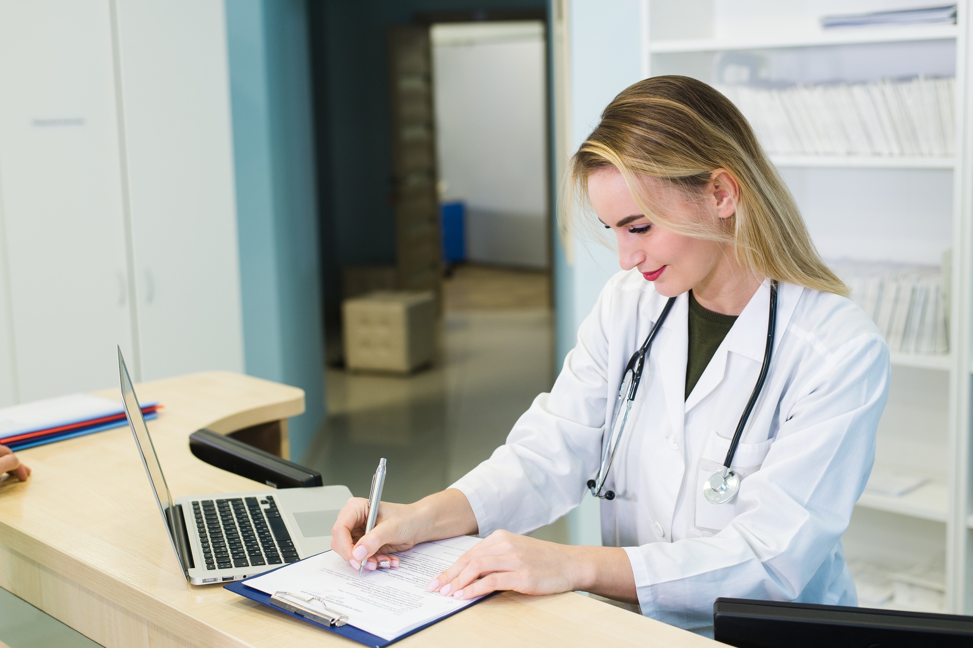 Young smiling receptionist in dental clinic