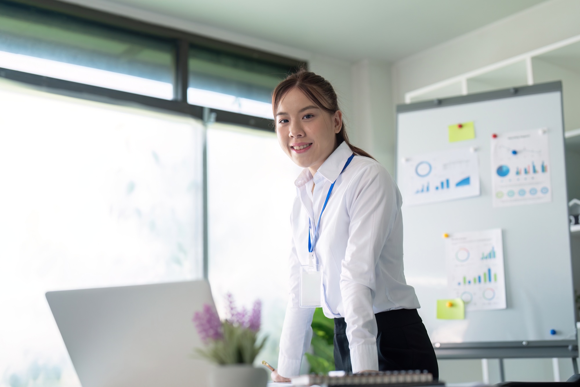 Young successful employee or business woman at desk at office. Achievement career concept