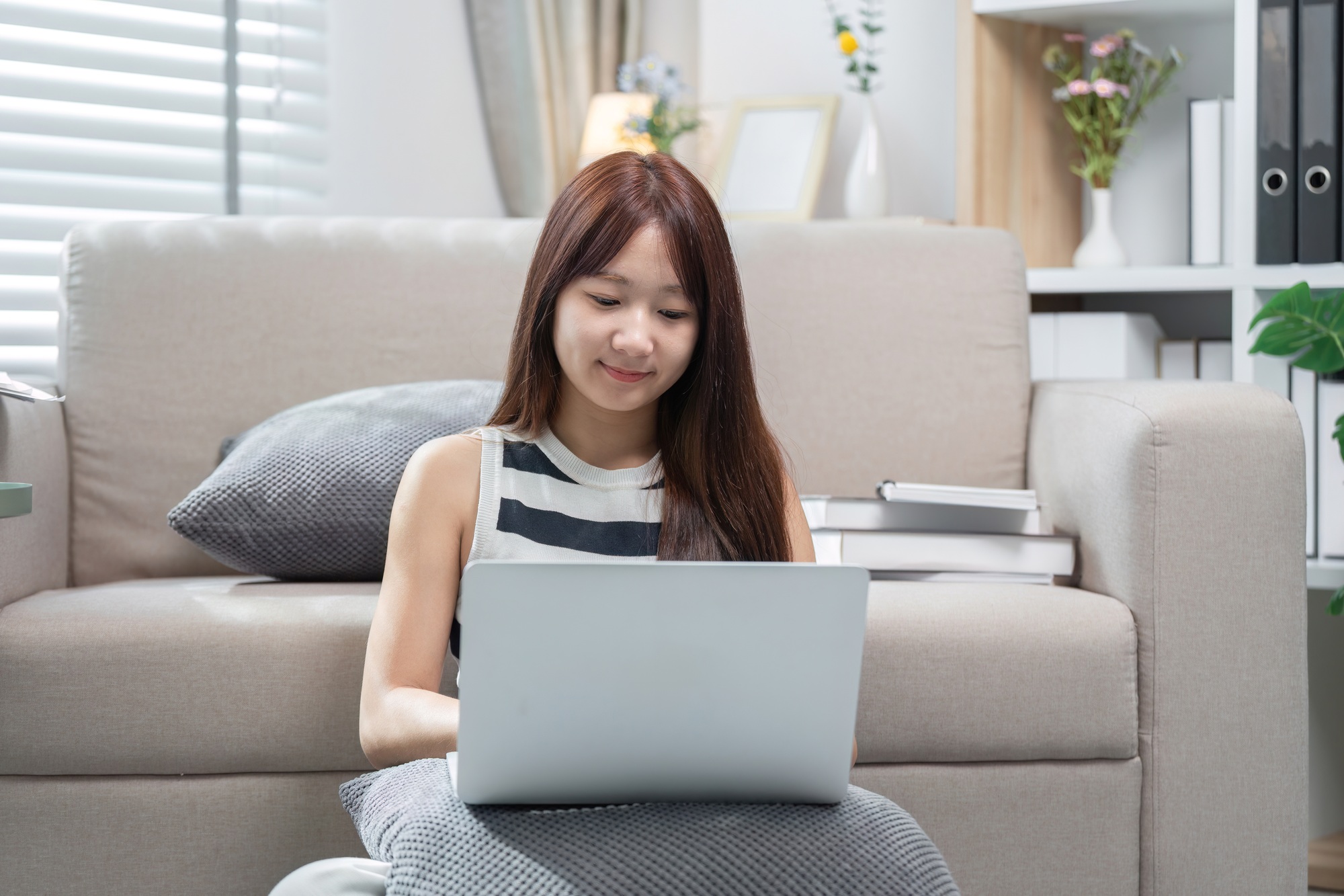 Young Woman Studying Online at Home with Laptop, Engaged in E-Learning, Remote Education, and Online
