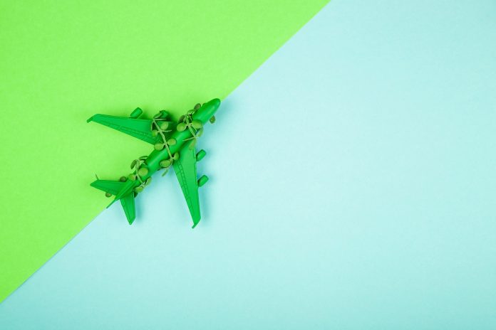 Sustainable aviation concept - green plane. Banner image, copy space.