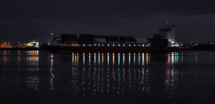 Beautiful photo of a tanker sailing with cargo through the strait at night