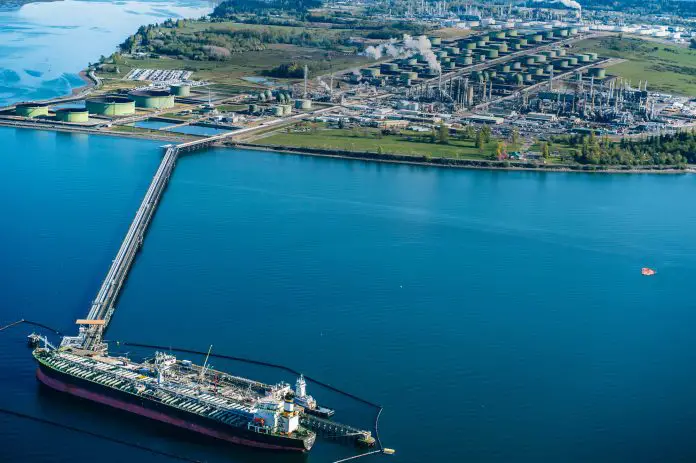 High angle view of oil transfer between oil refinery and oil tanker