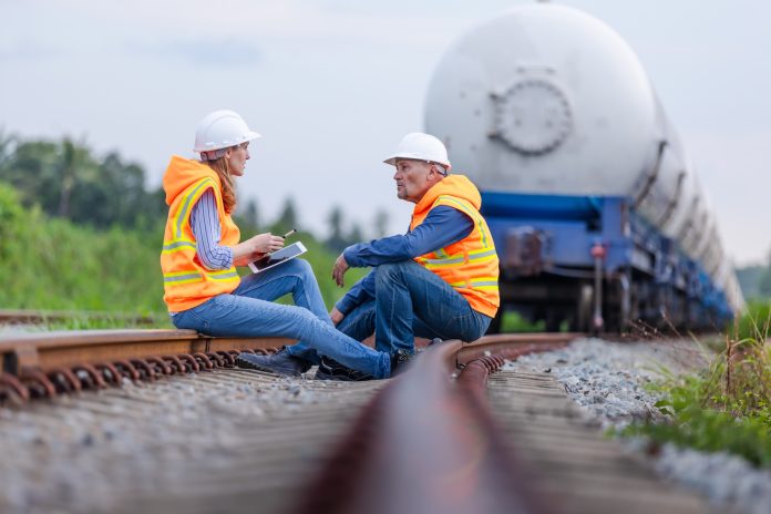 An engineer relaxes on the tracks of a natural gas train