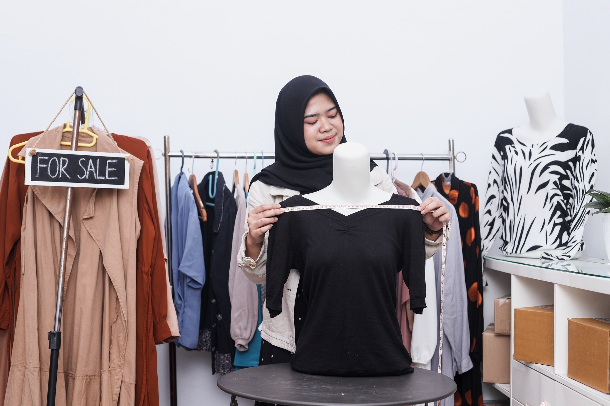 Asian muslim woman selling clothes online on social media