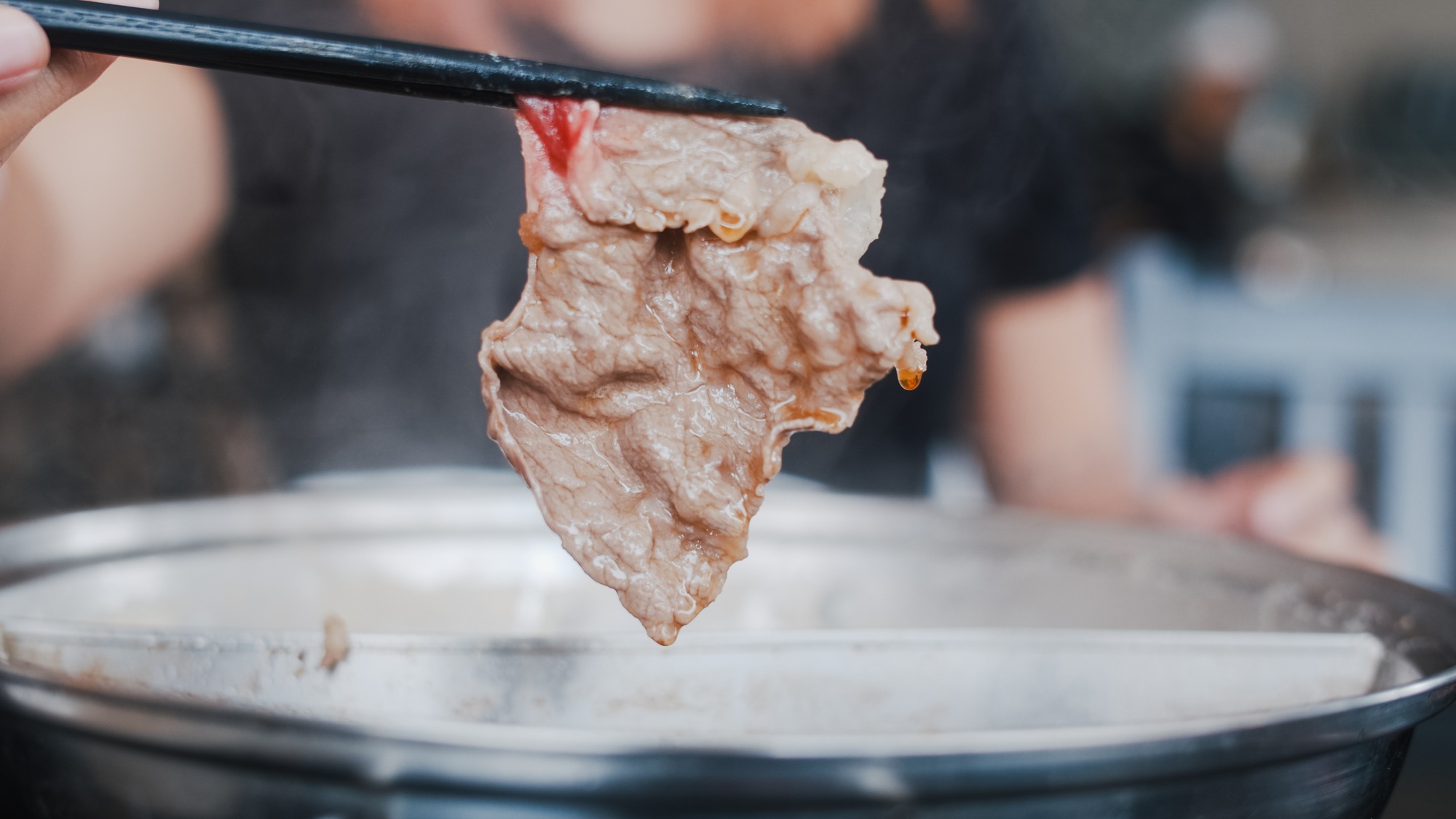 Asian woman eating hot pot in japanese restaurant.