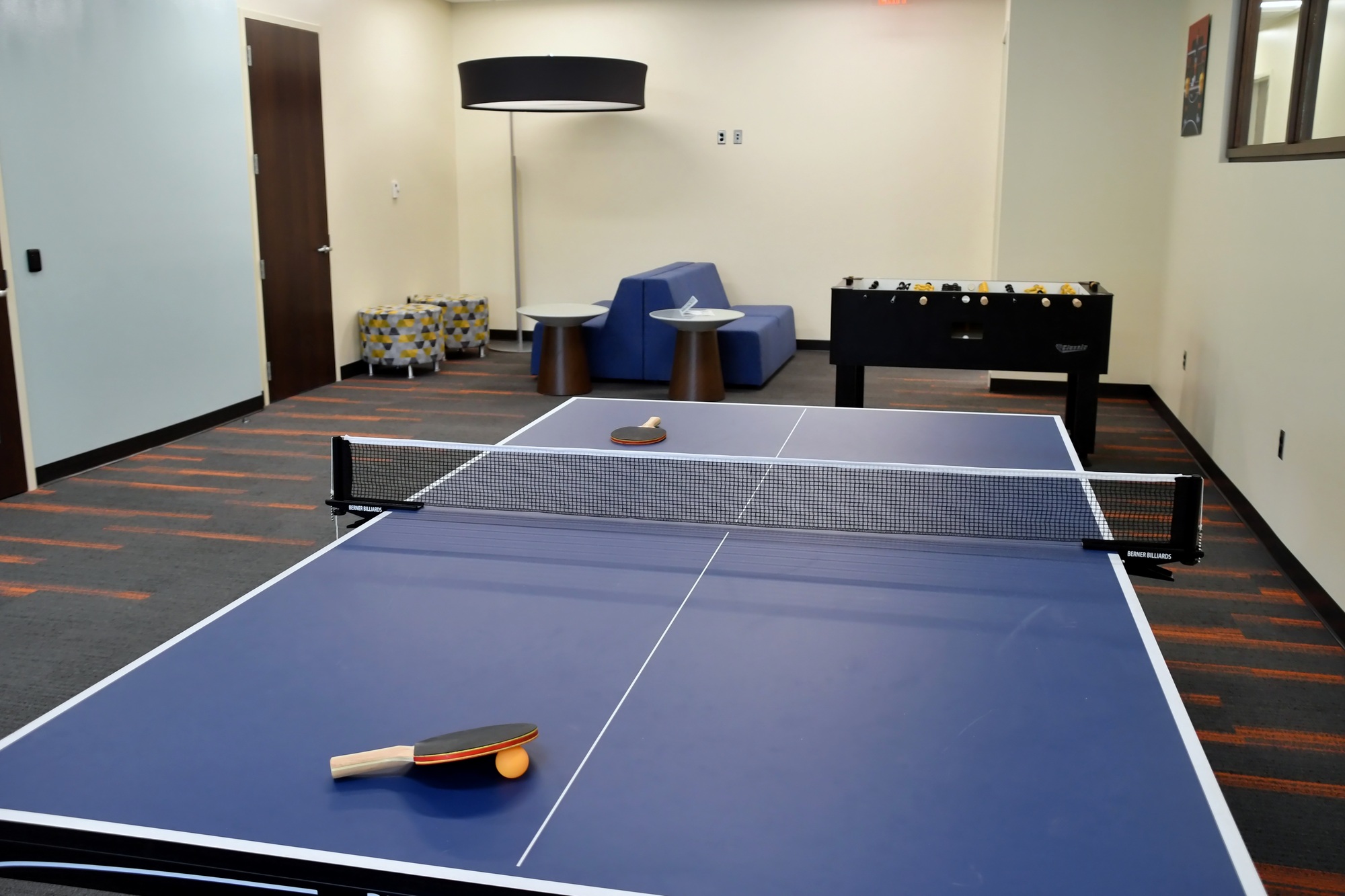 Clean, modern game room, break room, recreation area in an office building environment.