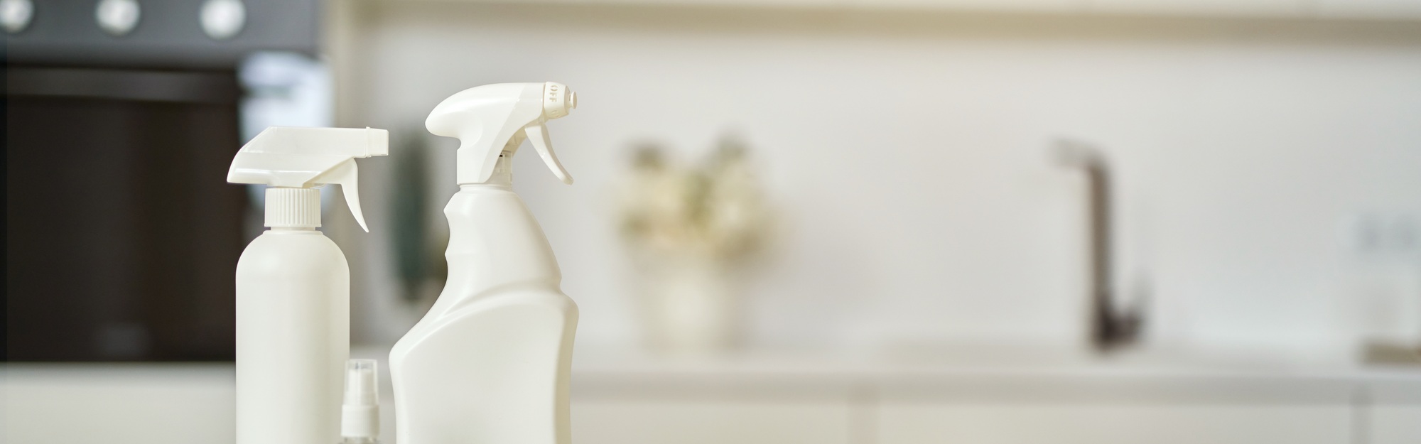 Cleaning set. Detergent bottles, stack of rugs and protective rubber gloves on surface in the