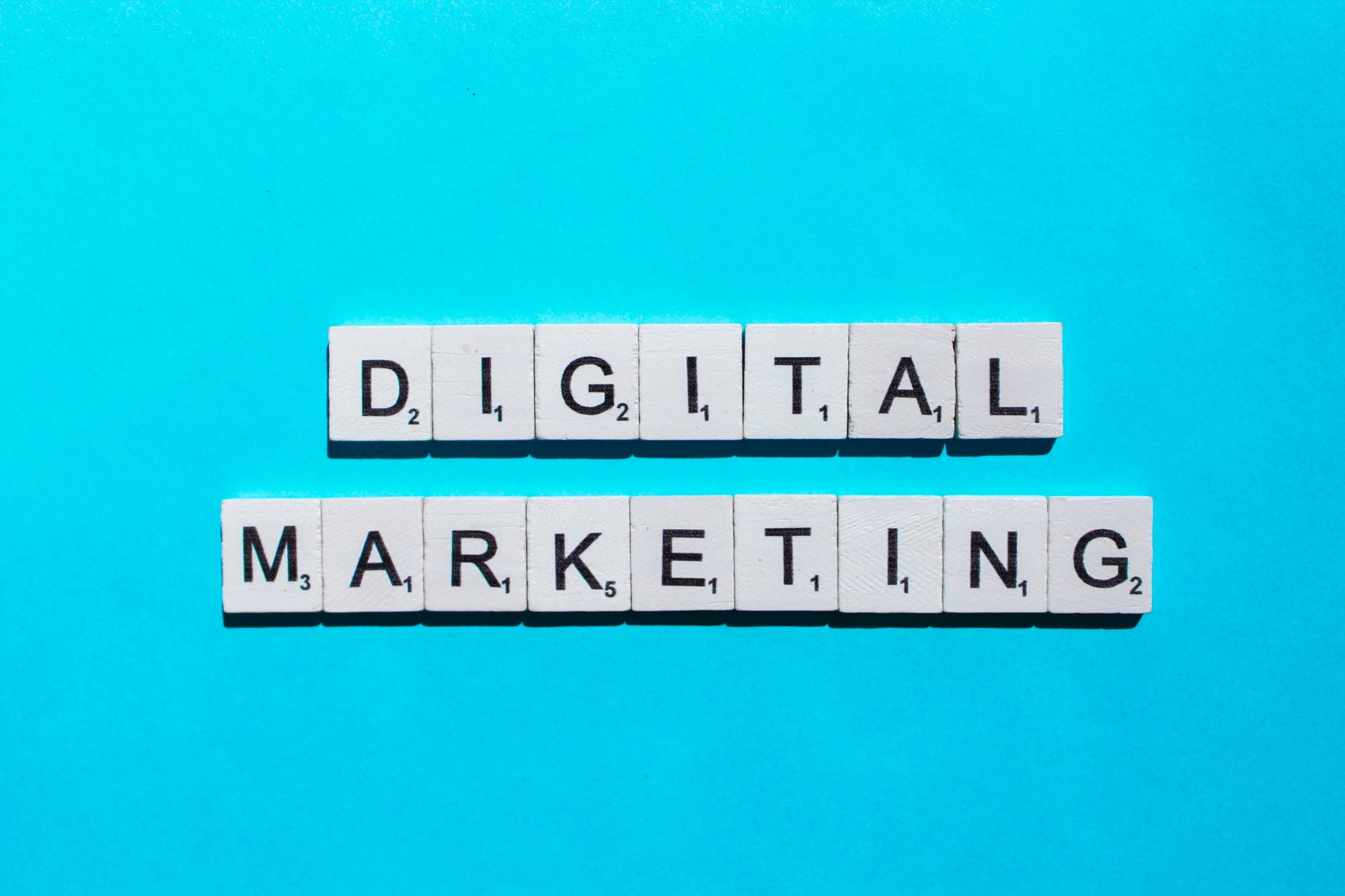 Digital marketing scrabble letters word on a blue background
