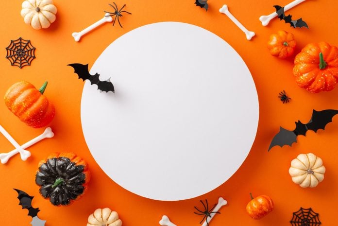 Enjoyable Halloween gathering concept. High-angle shot of pumpkins, paper bats, spiders