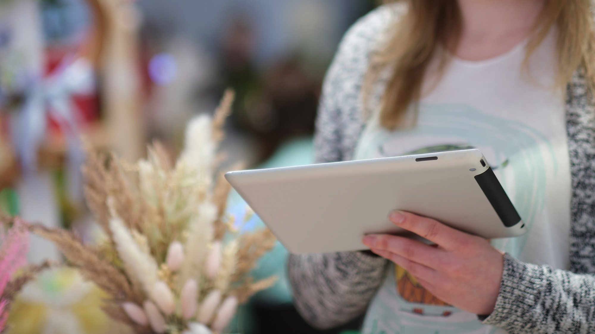 female uses a tablet to advertise their products and communicate with customers.