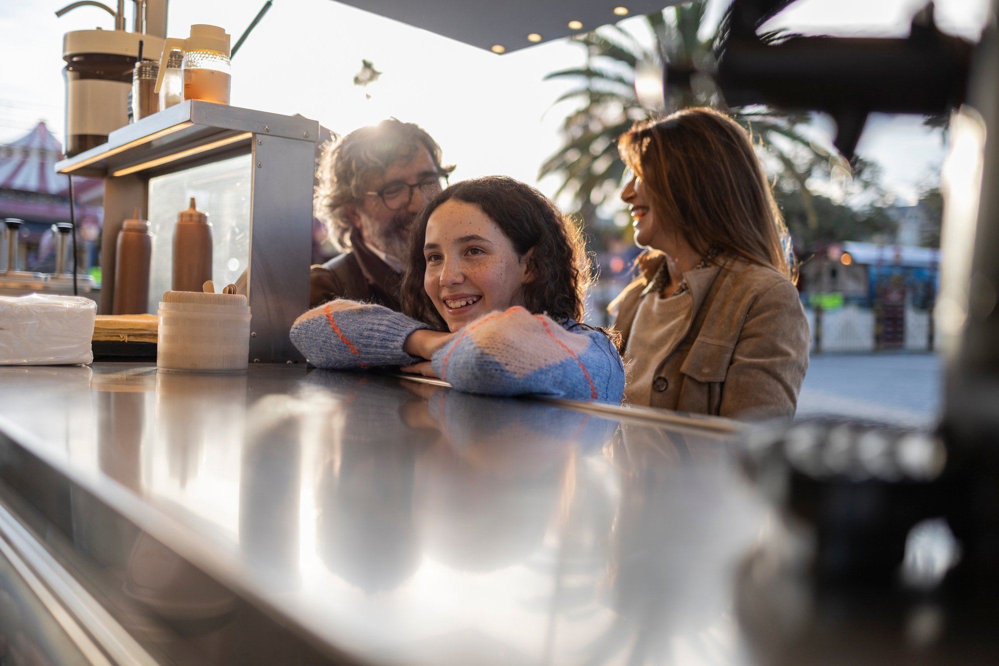 Happy family ordering street food at a food truck