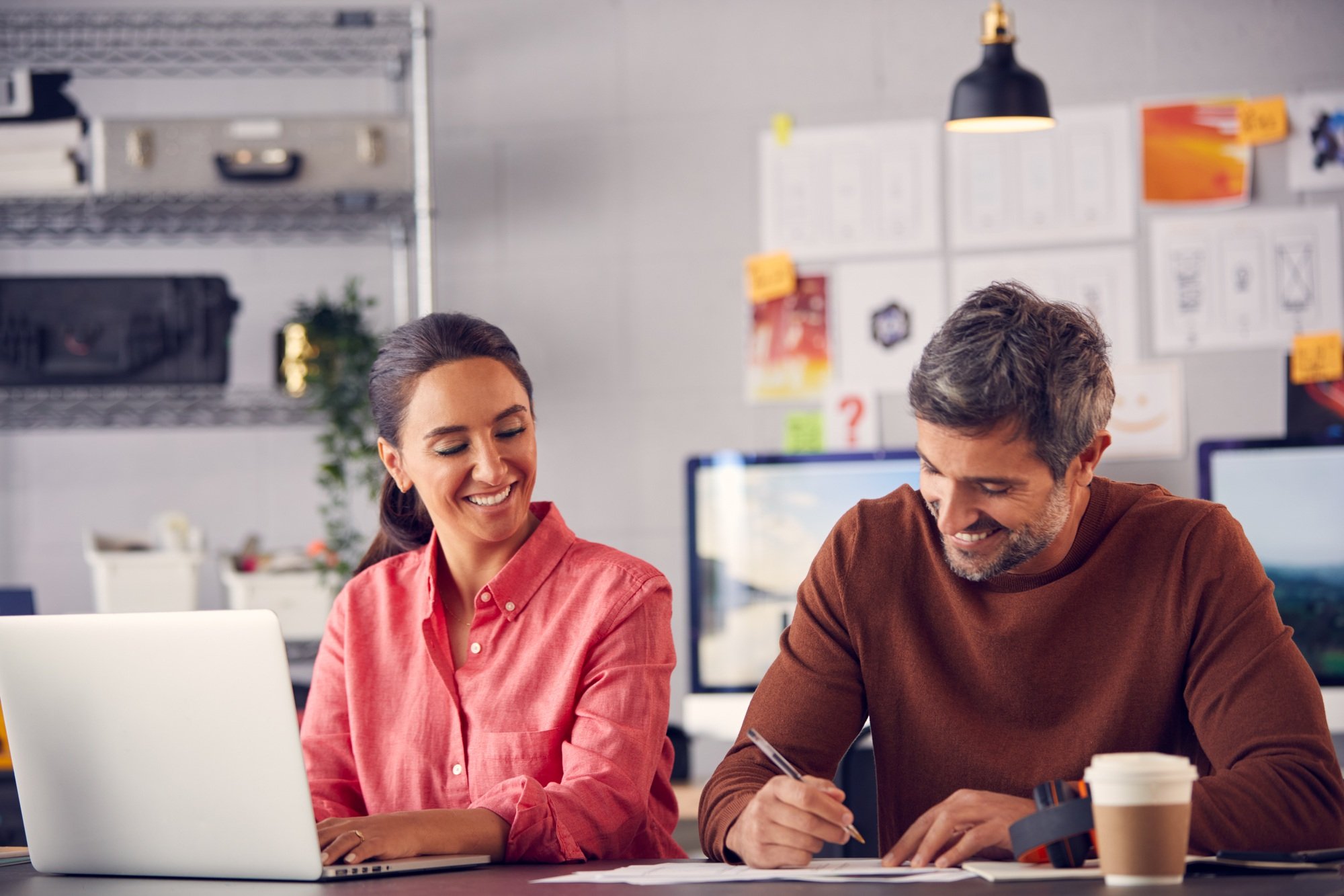 Male And Female Advertising Marketing Or Design Creatives Collaborating On Project In Studio