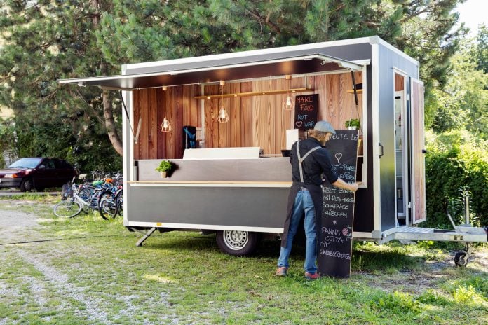 Man opening food truck for business, Innsbruck Tirol, Austria