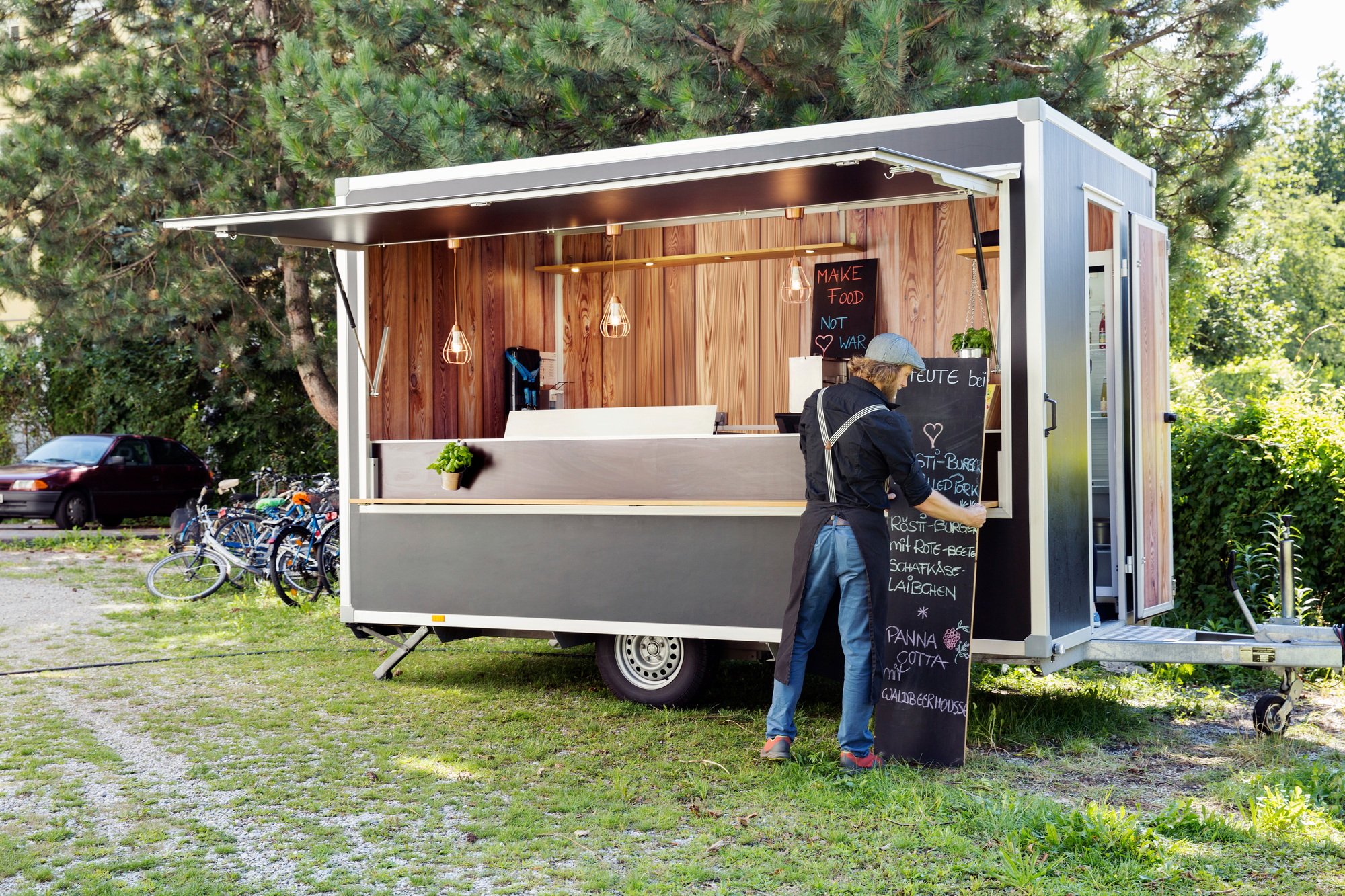 Man opening food truck for business, Innsbruck Tirol, Austria