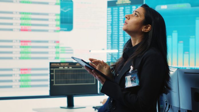 Marketing manager evaluating sales and profit within infographics data
