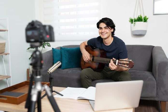 Musician and blogger recording a song online