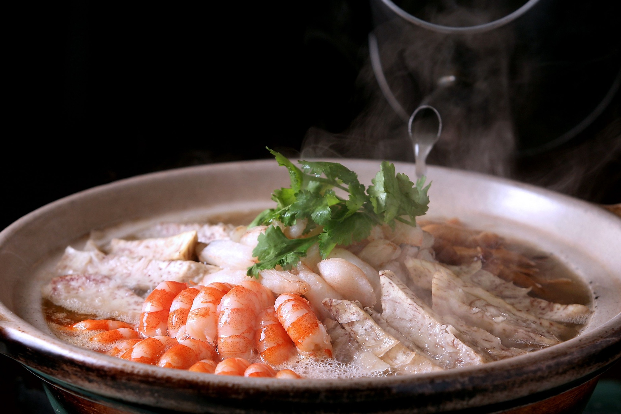 Steaming hot pot with shrimp and taro.