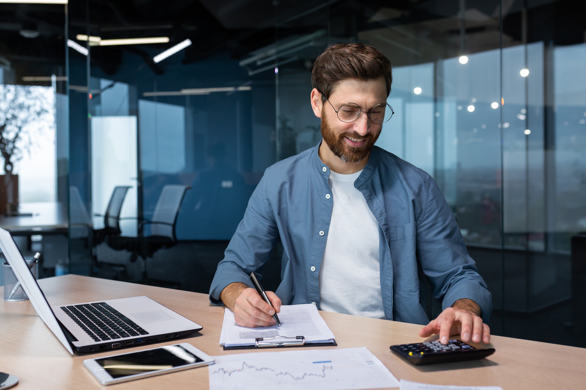 Successful financier investor works with documents and accounts inside office, businessman with