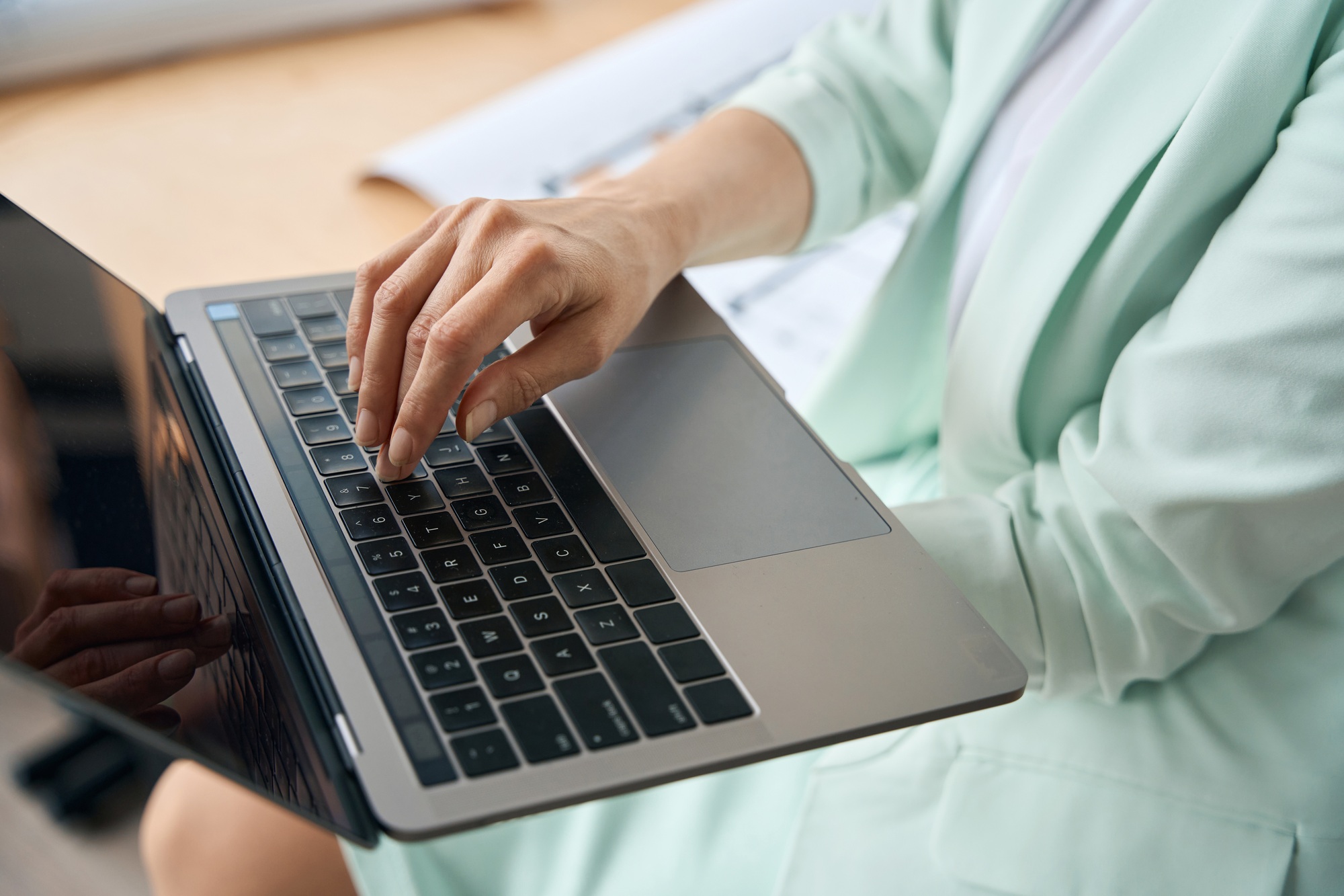 Well-dressed businesslady using her laptop at workplace