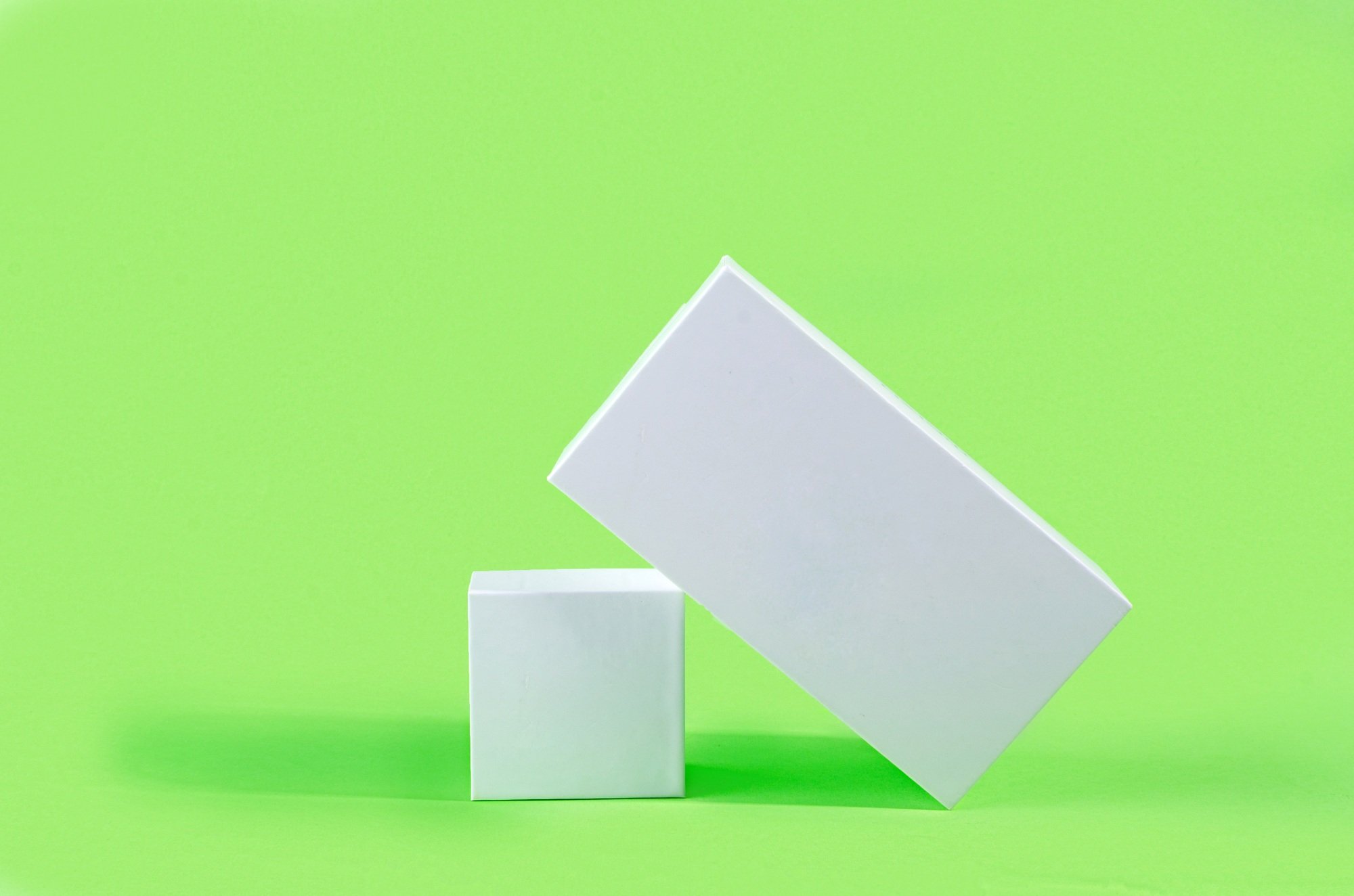 White geometric figure, a rectangular with shadows on a light green background.